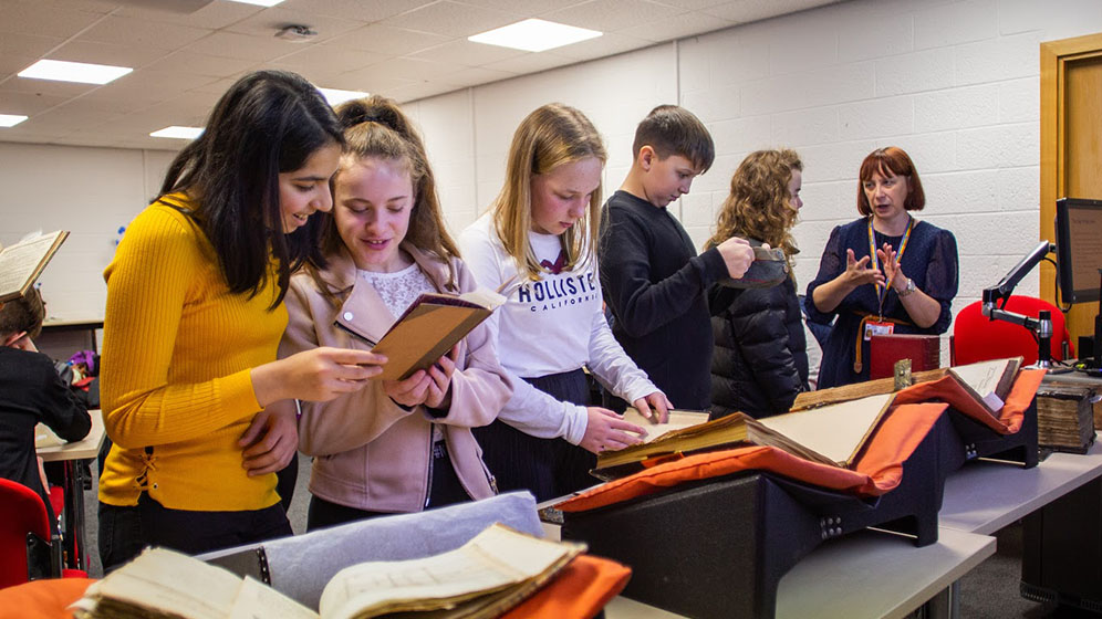 School children looking at Special Collections items